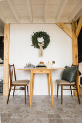 Decorated with wreath room and festive table serving in Christmas tradition  