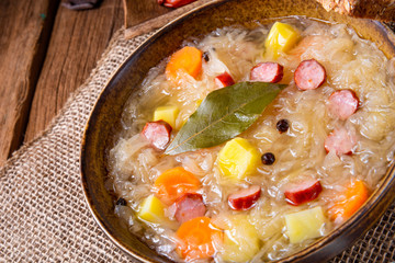 rustic sauerkraut soup with bacon and sausage
