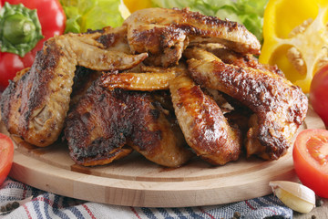 Chicken wings barbecue with different vegetables	