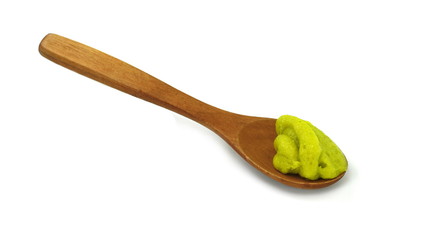 Green wasabi sauce in small wooden spoon isolated on white background