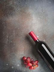 Wine bottle and grape  on stone dark background