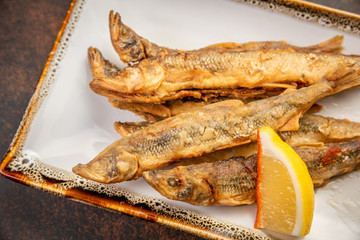 Crispy deep-fried small fish with lemon