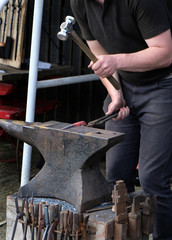 Blacsmith working on red hot metal.