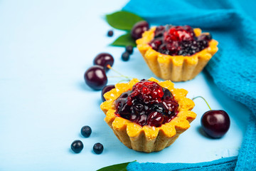 Small berry cake and ripe berries