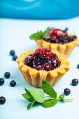 Small berry cake and ripe berries