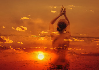 Double exposure of young woman and sunset sky.