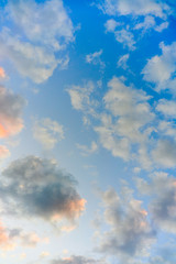 beautiful sunset with clouds painted in yellow white pink and blue colors. Beautiful sky with cloud before sunset