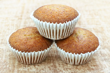 Close up stack of tree banana cup cake bakery, look delicious on wooden table background, vintage tone.