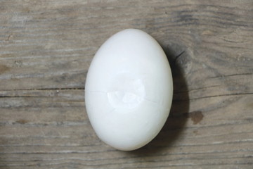 Single broke duck egg on wooden table background, have copyspace for put text