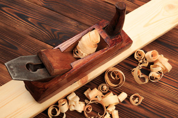 chisels plane and sawdust on a wooden table.