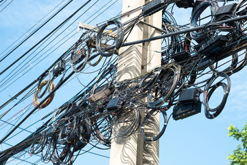 Messy electrical cables in thailand - many lines of cables chaotic set of interwoven, optical fiber...