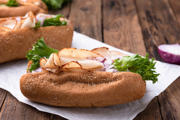Hotdog with breast turkey on wood