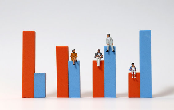 Miniature People Sitting On A Bar Graph. The Concept Of Declining Birth Rate And Aging Population.