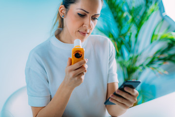 Woman using Spirometer, Measuring Lung Capacity and Force Expiratory Volume