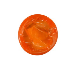 Red condom isolated on white background.