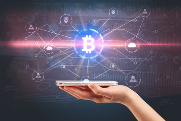 Hand using phone with cryptocurrency bitcoin link network and online concept
