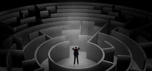 Businessman can not decide which entrance to chose in a middle of a dark maze
