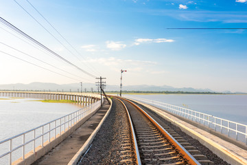 Fototapeta na wymiar Landscape View of Train crossing Pasak Chonlasit Dam. Reservoir for agriculture at Lopburi,Thailand