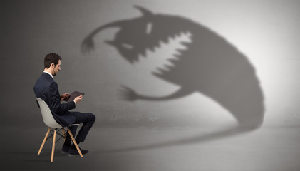 Young businessman staying and  negotiate with a monster shadow
