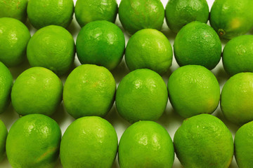 Many fresh limes on white background.