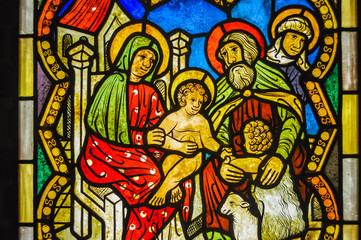 Fototapeta premium MALBORK, POLAND, 26 AUGUST 2018: Gothic and coloured glass with the holy family in Malbork Church