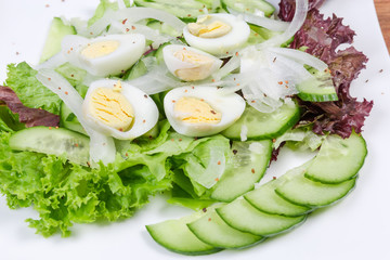Vegetable salad with boiled quail eggs close-up