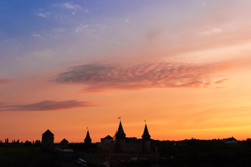 Silhouette of mediaeval fortress in Kamianets-Podilskyi at sunset, Ukraine