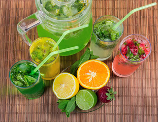 Top view of different cold mint drinks with fruit, berries
