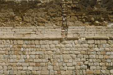 Ancien mur en pierre avec différentes strates historiques.
