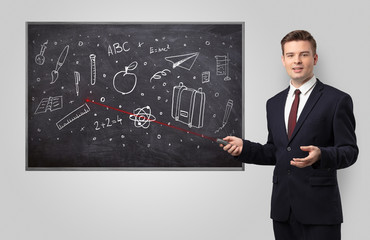 Handsome young teacher with laser pointer teaching 
