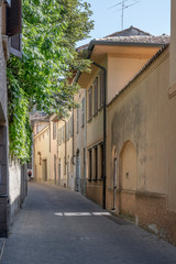 Fototapeta na wymiar cityscape with old houses on bending street, Crema, Italy