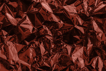 Brown deformed background made of tinted foil