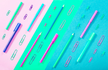 School background. Colorful stationary in blue, pink and green color. Back to school. Flat lay.
