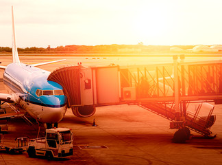jet bridge attached to the fuselage of a commercial aircraft to allow travelers to board