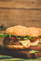 Craft beef burger  on wooden table isolated on black background.