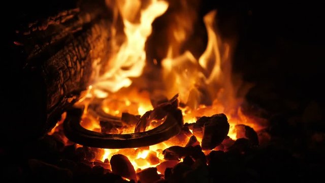 Ominous furnace flame with raging forks in an old Ukrainian smithy workshop