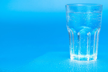 glass of water on a blue background