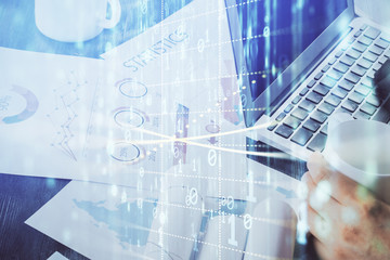 Multi exposure of technology hologram with man working on computer background. Concept of big data.