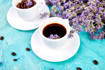 Coffee and lavender flower on blue background from above.