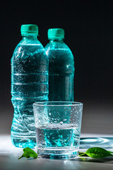 Served table set of mineral water bottle and glass