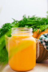 Carrot smoothie with parsley on a table