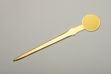 Envelope opener made of silver or brass with gold plating.