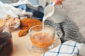 Hot masala chai, tea with milk poured over close up