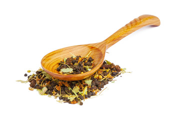 Dried tea on a wooden spoon, isolated on white