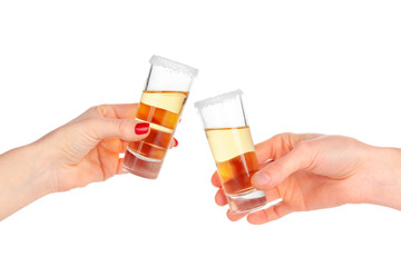 Two hands clinking glasses with shot cocktail isolated on white