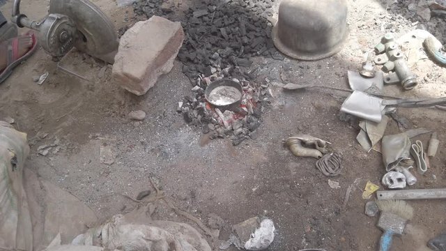 Indian metal workers casting Hindu God and Goddess idols using recycled up-cycled melted metal from everyday objects at a makeshift roadside workshop in India- 4k slow-motion handheld stabilized 