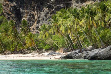 Beautiful Tropical beach in sunny day. Uninhabited island. Landscape of a tropical island and rocky mountains