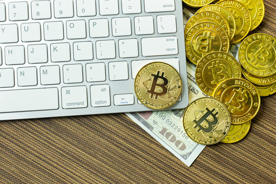 Bitcoin coin on silver keyboard for  cryptocurrency content.