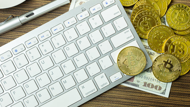 Bitcoin coin on silver keyboard for  cryptocurrency content.