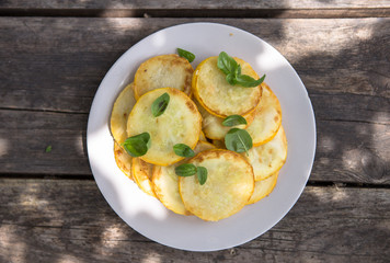 Pan fried zucchini fritters, traditional flat zucchini pancakes with garlic and green parsley